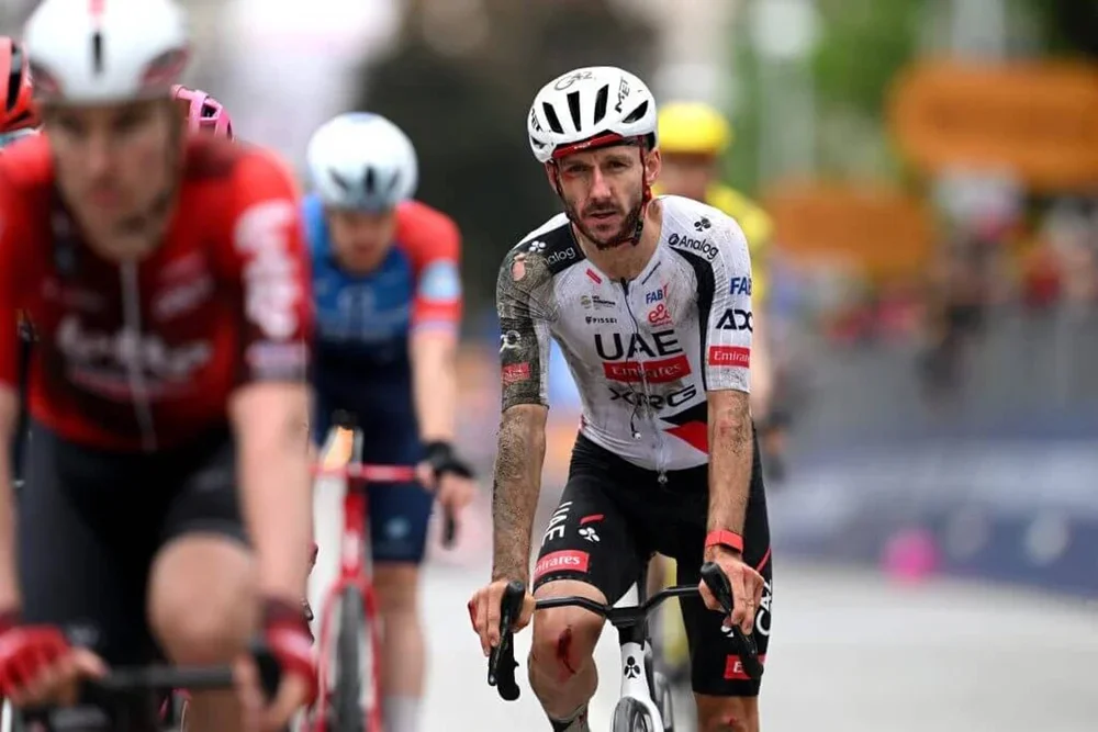 Adam Yates with rips in his jersey