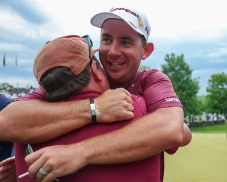 Lucas Herbert embraces a teammate in celebration after winning LIV Golf Virginia